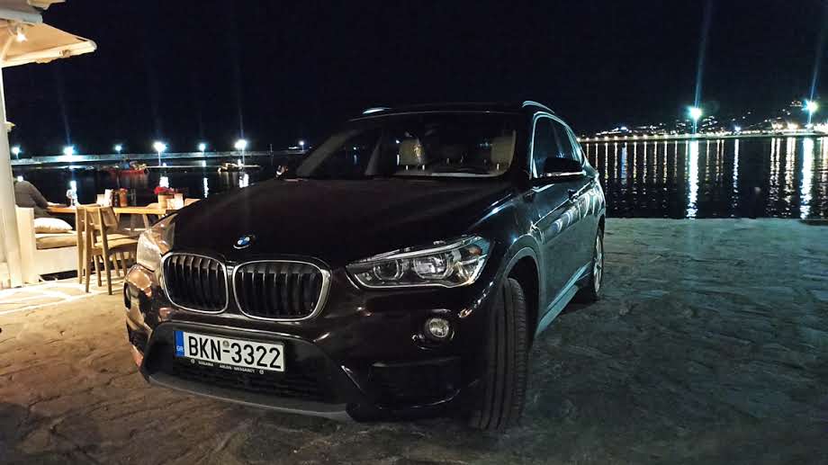 Private Angel Tours' BMW parked at night by the seaside